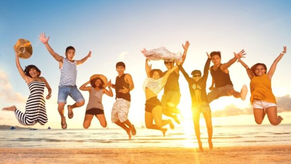 Group of friends jumping on beach, concept fun jump